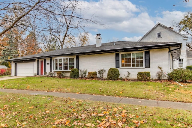 view of front of house with a garage, a front yard, brick siding, and driveway