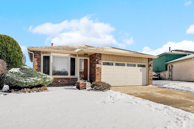 view of front of house with a garage, concrete driveway, and brick siding