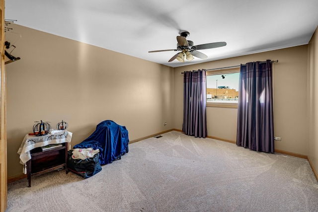 interior space featuring carpet floors, baseboards, and a ceiling fan