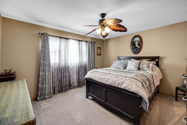 bedroom featuring light carpet, ceiling fan, and baseboards