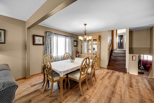 11621 S Merrion Ln, Merrionette Park, IL 60803 - dining space with a chandelier, stairway, baseboards, and light wood finished floors