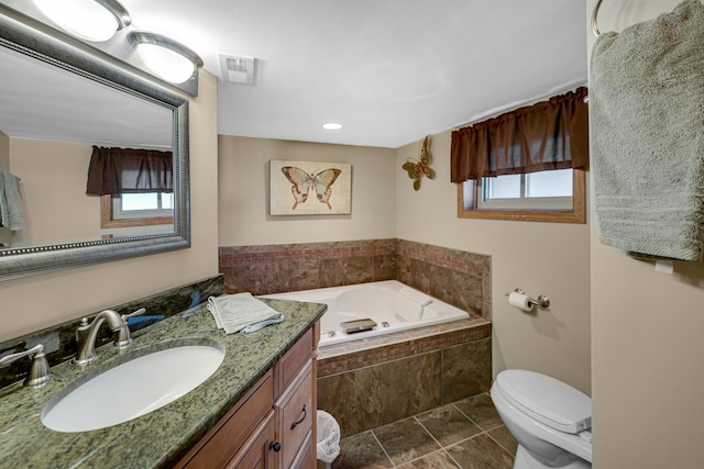 bathroom with toilet, vanity, visible vents, a bath, and tile patterned floors