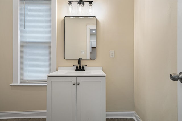 bathroom featuring baseboards and vanity