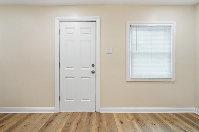 interior space featuring light wood-type flooring and baseboards