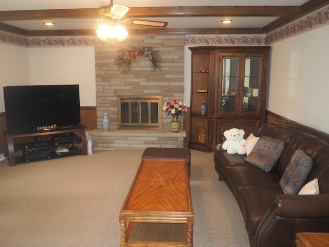 carpeted living room featuring wainscoting, beamed ceiling, and a fireplace