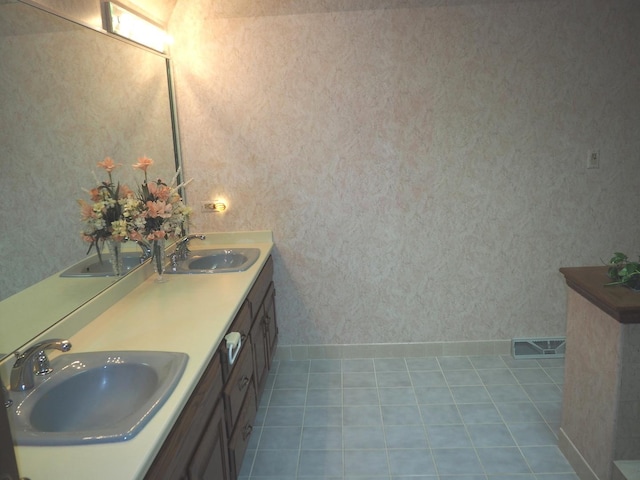 bathroom with tile patterned flooring, a sink, and visible vents