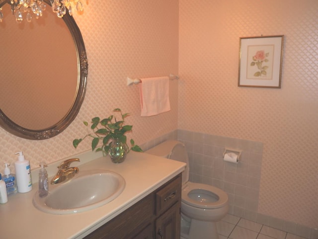 bathroom featuring tile patterned flooring, vanity, toilet, and wallpapered walls