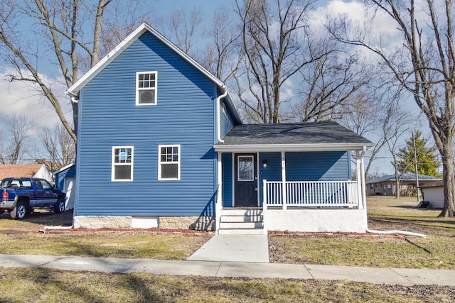 traditional-style home featuring covered porch