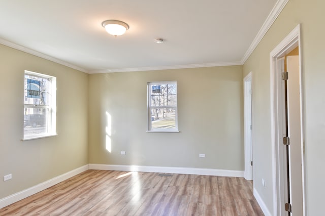 unfurnished room with baseboards, light wood-type flooring, and ornamental molding