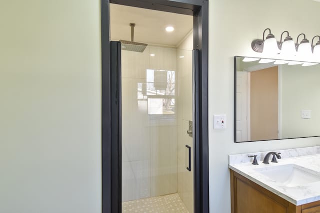 bathroom with a stall shower and vanity