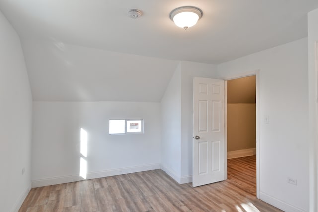 bonus room featuring vaulted ceiling, wood finished floors, and baseboards