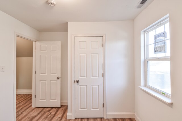 unfurnished bedroom with baseboards, visible vents, and light wood finished floors