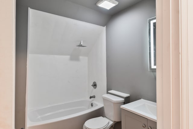 bathroom featuring bathing tub / shower combination, lofted ceiling, toilet, and vanity