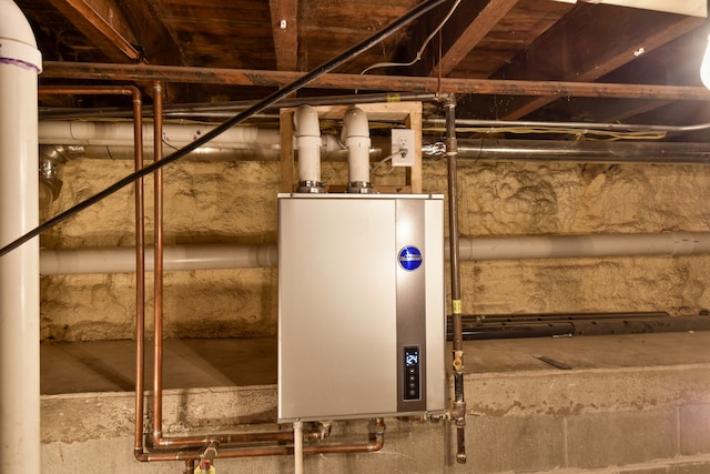 utility room featuring water heater