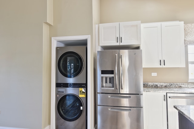 laundry area featuring stacked washing maching and dryer