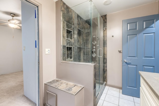 bathroom with a shower stall, ceiling fan, tile patterned flooring, and vanity