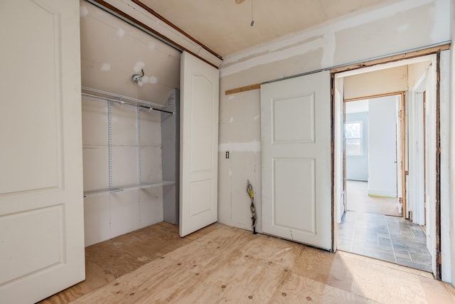 unfurnished bedroom featuring light wood-type flooring and a closet