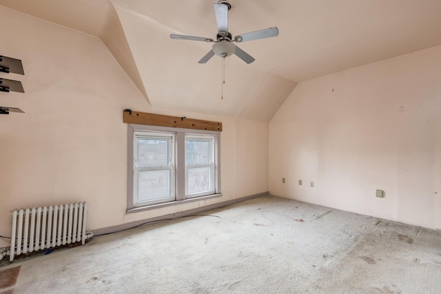 bonus room with radiator, ceiling fan, carpet floors, and vaulted ceiling