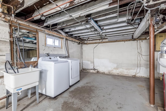 below grade area with washing machine and dryer and a sink