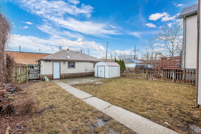 view of yard with an outbuilding, a shed, and a fenced backyard