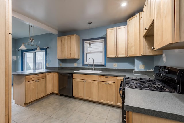 kitchen with dark countertops, black appliances, a peninsula, and a sink