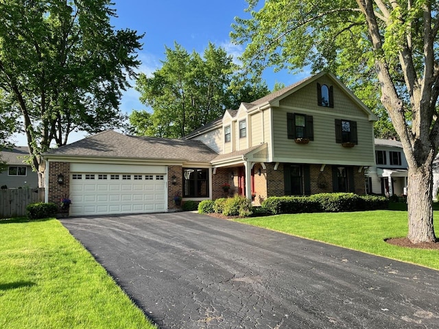 view of front of property with a garage, brick siding, fence, driveway, and a front yard