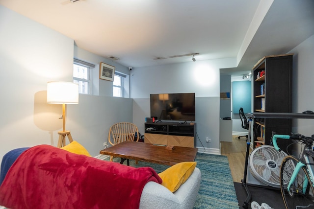 living room featuring visible vents, wood finished floors, and track lighting