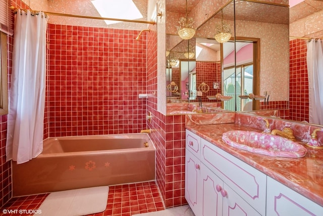 full bathroom with tile patterned flooring, wallpapered walls, vanity, and shower / tub combo