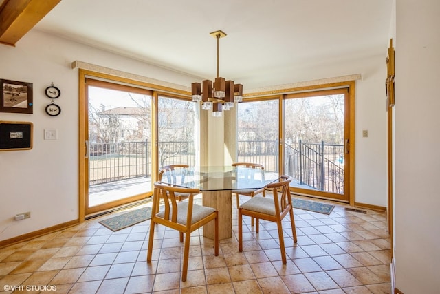 dining room featuring light tile patterned floors, plenty of natural light, and a chandelier