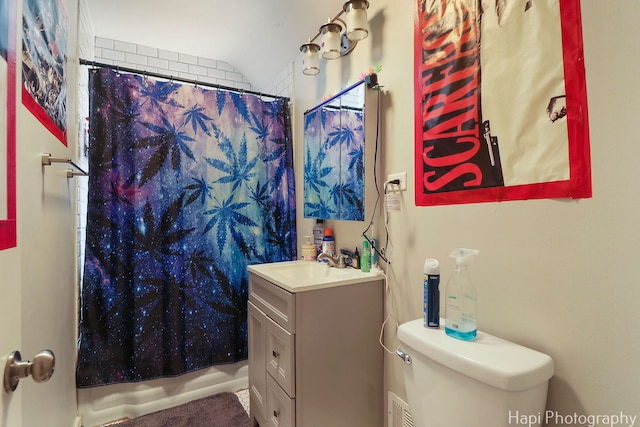 bathroom featuring shower / bathtub combination with curtain, toilet, and vanity