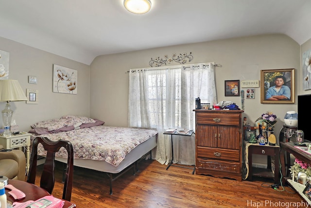 bedroom featuring lofted ceiling and wood finished floors