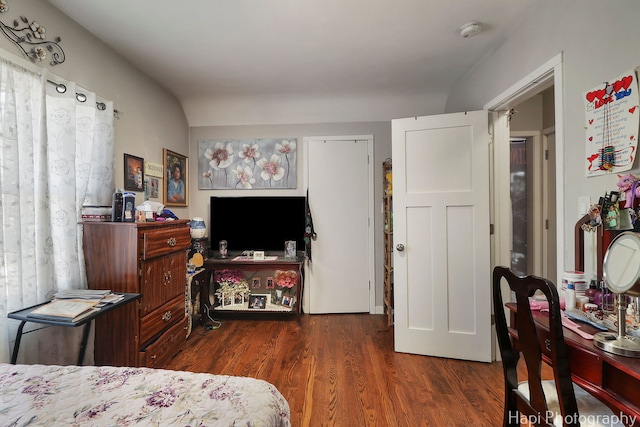 bedroom with dark wood-style flooring