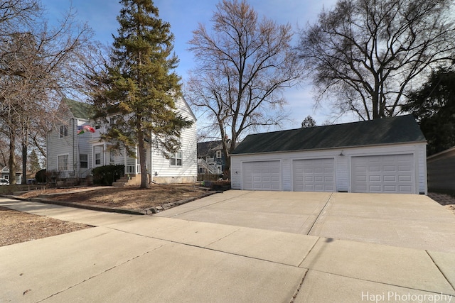 view of front facade with an outbuilding and a detached garage