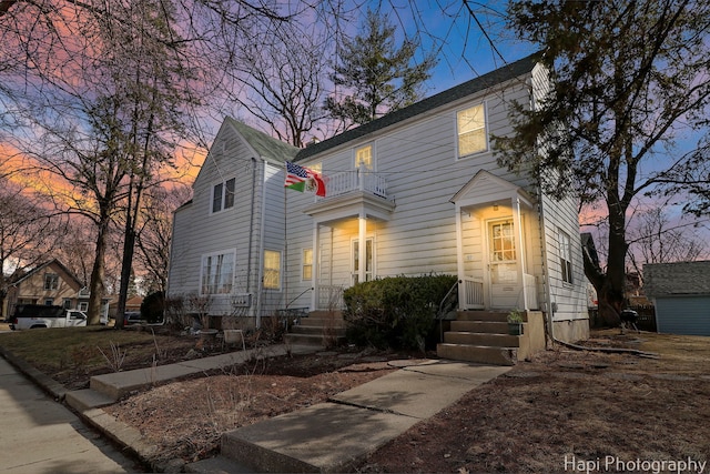 view of front of house featuring entry steps and a balcony