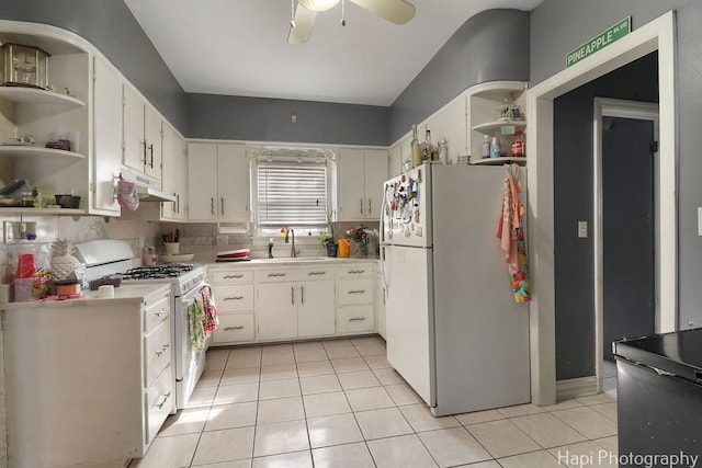 kitchen with light tile patterned floors, a sink, white appliances, and open shelves