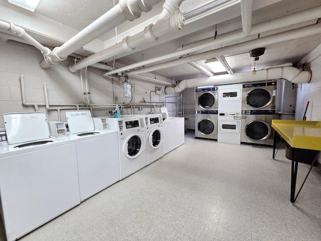 common laundry area featuring light floors, washer and clothes dryer, and stacked washer and clothes dryer