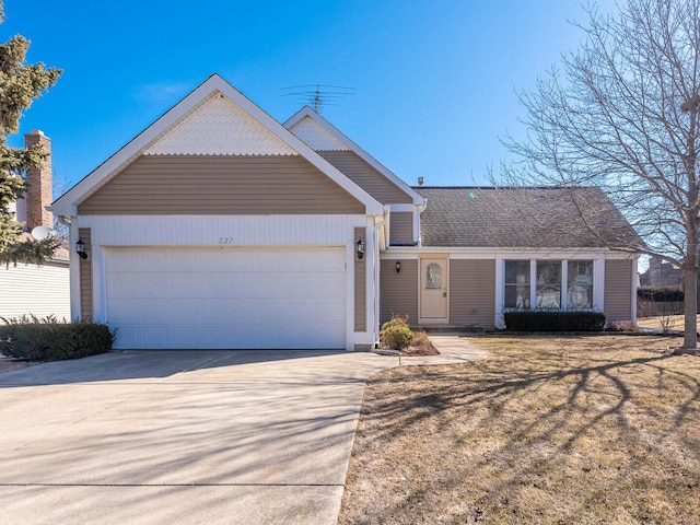 view of front of house with concrete driveway and an attached garage