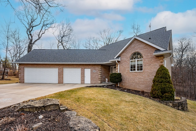 ranch-style house featuring a front yard, concrete driveway, brick siding, and roof with shingles