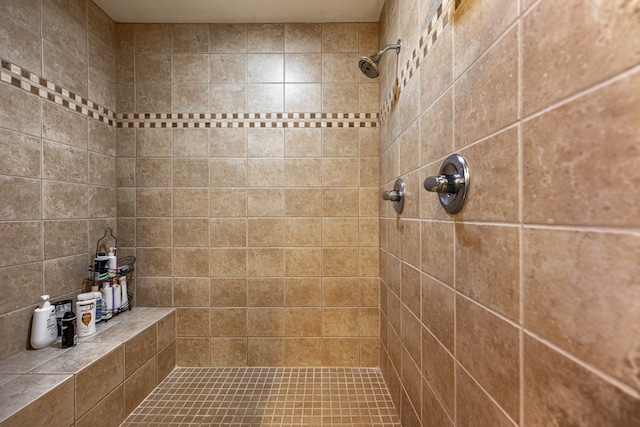 bathroom with tiled shower