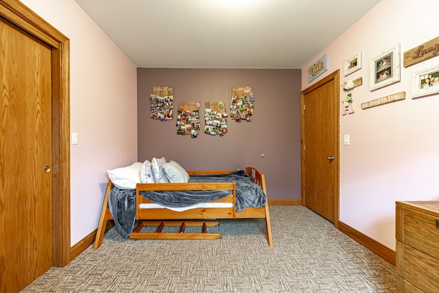 bedroom with baseboards and carpet flooring