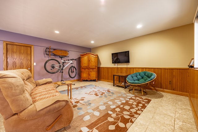 living area featuring a wainscoted wall, wood walls, and recessed lighting