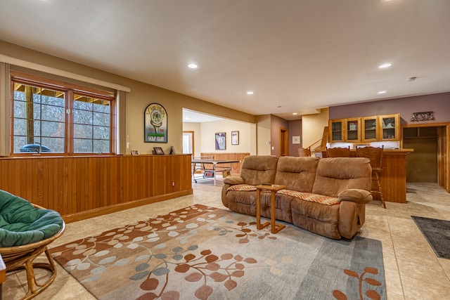 living room with recessed lighting, wainscoting, and wooden walls