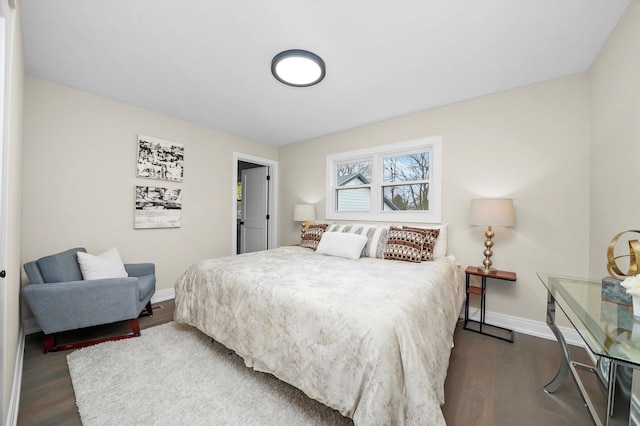 bedroom featuring dark wood-style floors and baseboards