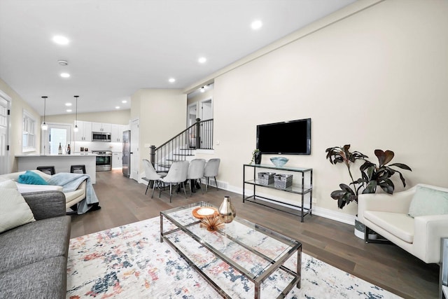 living room featuring baseboards, stairway, dark wood finished floors, and recessed lighting