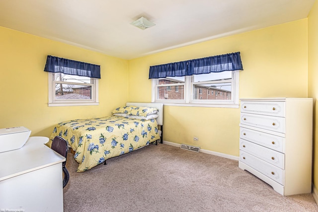 carpeted bedroom with baseboards and visible vents