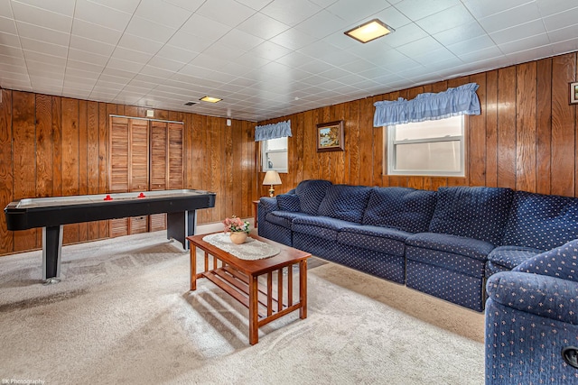 interior space with carpet and wooden walls