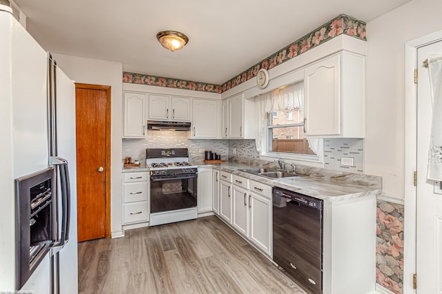 kitchen featuring range with gas stovetop, black dishwasher, fridge with ice dispenser, a sink, and under cabinet range hood