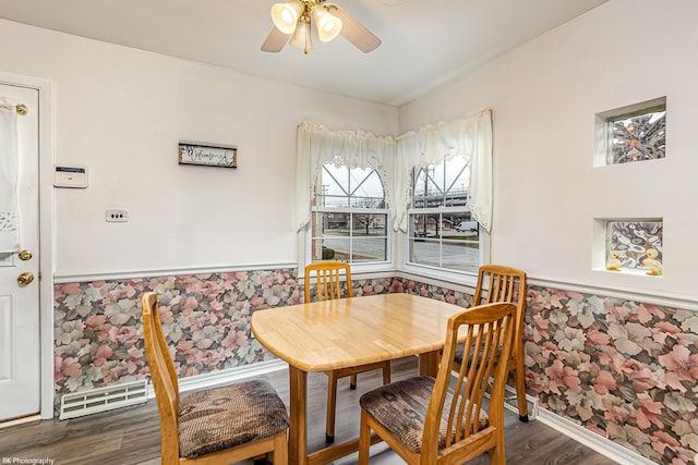 dining area with wainscoting, ceiling fan, visible vents, and wood finished floors