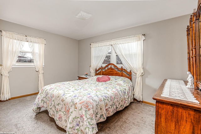 carpeted bedroom featuring baseboards