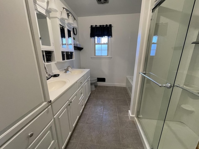 full bath featuring tile patterned floors, baseboards, a sink, and a shower with shower door